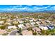 Scenic aerial view of a suburban neighborhood with neatly arranged homes, solar panels, and a clear blue sky overhead at 4944 E Dale Ln, Cave Creek, AZ 85331
