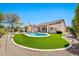 Expansive backyard features a pebble tec pool, artificial grass, and desert landscaping at 4944 E Dale Ln, Cave Creek, AZ 85331