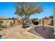 Picturesque backyard with travertine pavers, dining set, built-in BBQ, and desert landscaping at 4944 E Dale Ln, Cave Creek, AZ 85331