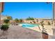 Private backyard featuring a pebble tec pool, travertine pavers, artificial grass, and desert landscape at 4944 E Dale Ln, Cave Creek, AZ 85331