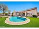 Beautiful backyard featuring a pool, artificial grass, and patio seating, perfect for outdoor living at 4944 E Dale Ln, Cave Creek, AZ 85331