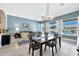 Elegant dining room with a modern chandelier, stylish table, and views of the living area and backyard at 4944 E Dale Ln, Cave Creek, AZ 85331