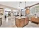Expansive kitchen features tile floors, island with granite countertops, stainless steel appliances, and large windows at 4944 E Dale Ln, Cave Creek, AZ 85331