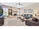 Comfortable living room featuring stone fireplace, mounted TV, ceiling fan, and large, comfy sofas at 4944 E Dale Ln, Cave Creek, AZ 85331