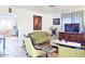 Comfortable living room with an open layout showcasing an olive sofa, accent chairs, and a view into the kitchen at 500 W Coolidge St, Phoenix, AZ 85013