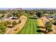 Expansive aerial view of the meticulously maintained golf course and water feature surrounded by lush trees and desert landscaping at 576 W Moon Valley Dr, Phoenix, AZ 85023