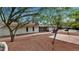Large backyard with brick pavers, mature trees, and landscaping, providing a private and peaceful retreat at 576 W Moon Valley Dr, Phoenix, AZ 85023