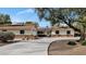 Charming ranch-style home with a manicured lawn, solar panels, and a spacious driveway at 576 W Moon Valley Dr, Phoenix, AZ 85023