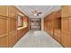 Hallway with custom built-in cabinets and carpet flooring, providing ample storage space at 576 W Moon Valley Dr, Phoenix, AZ 85023