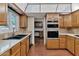 Traditional kitchen with wood cabinets, tile countertops, and stainless steel appliances at 576 W Moon Valley Dr, Phoenix, AZ 85023