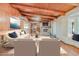 Cozy living room features a stone fireplace, wooden beam ceilings, and comfortable seating arrangements at 576 W Moon Valley Dr, Phoenix, AZ 85023