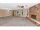 Spacious living room features a brick fireplace, plush carpet, and sliding glass doors to the outdoors at 576 W Moon Valley Dr, Phoenix, AZ 85023