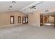 Bright living room with neutral carpet, vaulted ceilings, and access to a screened-in porch at 576 W Moon Valley Dr, Phoenix, AZ 85023