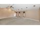 Bright living room with neutral carpet, vaulted ceilings, and abundant natural light at 576 W Moon Valley Dr, Phoenix, AZ 85023