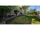 This spacious backyard features green grass, mature trees and a covered patio at 5924 W Running Deer Trl, Phoenix, AZ 85083