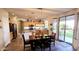 Open-concept dining area adjacent to the kitchen, featuring a dining table set, sliding glass doors, and ample lighting at 5924 W Running Deer Trl, Phoenix, AZ 85083
