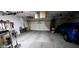 Inside of an organized garage with tools and storage. A blue SUV is parked inside at 5924 W Running Deer Trl, Phoenix, AZ 85083
