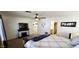 This cozy main bedroom boasts a decorative fireplace, ceiling fan and ensuite bathroom access at 5924 W Running Deer Trl, Phoenix, AZ 85083