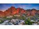 Picturesque aerial view of a desert residential community nestled amidst the mountain landscape at sunset at 5935 N Echo Canyon Ln, Phoenix, AZ 85018