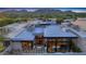 Expansive home with modern architectural design, large windows, and an inviting outdoor patio at 5935 N Echo Canyon Ln, Phoenix, AZ 85018