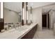 Sleek bathroom vanity with marble countertop, elegant fixtures, and well-lit mirrors at 5935 N Echo Canyon Ln, Phoenix, AZ 85018