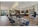 Dining area flows into the kitchen, featuring a glass table and contemporary lighting at 5935 N Echo Canyon Ln, Phoenix, AZ 85018