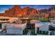 Luxurious home with modern design, a mountain backdrop, and a well-maintained landscape at 5935 N Echo Canyon Ln, Phoenix, AZ 85018