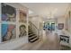 Bright foyer with hardwood floors, modern staircase and vibrant art collection at 5935 N Echo Canyon Ln, Phoenix, AZ 85018