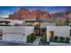 Modern home with manicured landscaping and a two-car garage, set against a mountain backdrop at 5935 N Echo Canyon Ln, Phoenix, AZ 85018