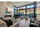 Cozy living room with fireplace, piano, and floor-to-ceiling windows with mountain views at 5935 N Echo Canyon Ln, Phoenix, AZ 85018