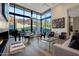 Elegant living room boasts floor-to-ceiling windows, a grand piano, and stylish furnishings at 5935 N Echo Canyon Ln, Phoenix, AZ 85018