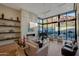 Bright living room with fireplace, piano, and floor-to-ceiling windows with mountain views at 5935 N Echo Canyon Ln, Phoenix, AZ 85018
