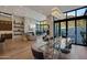 Elegant living and dining space with floor-to-ceiling windows and modern chandelier at 5935 N Echo Canyon Ln, Phoenix, AZ 85018