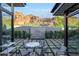 Outdoor patio with modern furniture, tiled waterfall feature and mountain views at 5935 N Echo Canyon Ln, Phoenix, AZ 85018