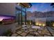 Outdoor patio with modern furniture, tiled waterfall feature and mountain views at sunset at 5935 N Echo Canyon Ln, Phoenix, AZ 85018