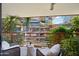 Balcony view of courtyard featuring plants, chairs, and a small table at 7131 E Rancho Vista Dr # 4003, Scottsdale, AZ 85251