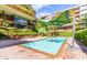 Outdoor pool with lounge seating, umbrellas, and surrounded by lush landscaping at 7131 E Rancho Vista Dr # 4003, Scottsdale, AZ 85251