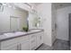 Bright bathroom featuring a double sink vanity with neutral countertops and modern fixtures at 7573 W Quail Track Dr, Peoria, AZ 85383