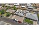 Aerial view of house with solar panels, modern backyard including mini golf, patio and fire pit at 829 W Mitchell Dr, Phoenix, AZ 85013