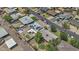Aerial view of neighborhood with solar panels, modern backyard including mini golf, patio and fire pit at 829 W Mitchell Dr, Phoenix, AZ 85013