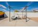 Backyard patio with pergola, cozy seating, string lights, and a painted block wall at 829 W Mitchell Dr, Phoenix, AZ 85013