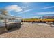 Expansive backyard showcases a hot tub, rock landscaping, putting green, and covered patio area at 829 W Mitchell Dr, Phoenix, AZ 85013