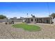 Fully renovated backyard featuring a mini-golf course, seating, and desert landscaping at 829 W Mitchell Dr, Phoenix, AZ 85013