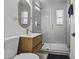 Bright bathroom featuring a modern vanity, gold fixtures, and a glass-enclosed shower with gray tile at 829 W Mitchell Dr, Phoenix, AZ 85013
