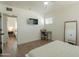 Bedroom with a bed, mirror, television and adjacent room visible at 829 W Mitchell Dr, Phoenix, AZ 85013