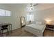 Bright bedroom with a desk and a window at 829 W Mitchell Dr, Phoenix, AZ 85013