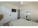 Bedroom with a bed, a TV and a full length mirror at 829 W Mitchell Dr, Phoenix, AZ 85013