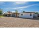 Single-story home with a front yard with gravel landscaping, a carport, and a neutral color scheme at 829 W Mitchell Dr, Phoenix, AZ 85013