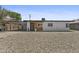 Delightful single-story home featuring a modern front door, desert landscaping, and a convenient carport at 829 W Mitchell Dr, Phoenix, AZ 85013