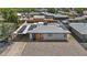 Charming home featuring solar panels, gravel landscaping, and a convenient covered carport for easy parking at 829 W Mitchell Dr, Phoenix, AZ 85013